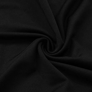 Macro detail of high-density black knit fabric showing sleek texture and subtle satin sheen