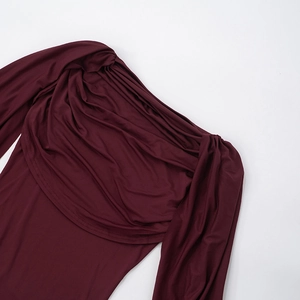 Detail of the draped neckline and soft burgundy knit fabric with pleated texture
