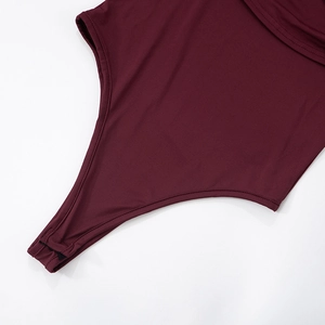 Detail shot of the burgundy bodysuit featuring secure snap button closures and elastic seams