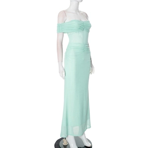 Detailed view of the ruched mint green mesh fabric and strapless design of this gown