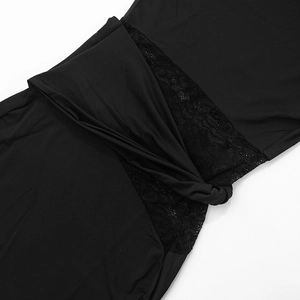 Detailed close-up of black sleeveless dress featuring lace inserts and a front twist knot