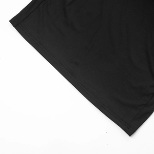 Detailed close-up of double-needle hem stitching on black sleeveless lace dress fabric