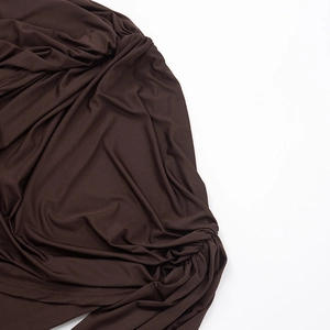 Close-up of dark brown slim fit dress showing draped cowl neck and soft pleated fabric