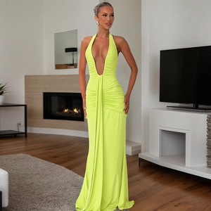 Detail of elegant lime green halter maxi dress with plunge neckline and ruched textures