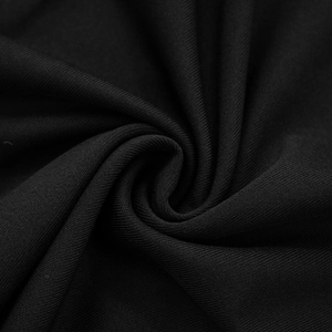 Close-up detail of premium black ribbed fabric with soft texture and vertical stripe patterns