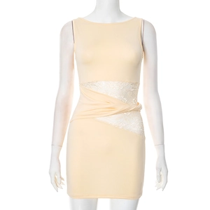 Detail shot of apricot sleeveless dress showing the waist twist and white lace patchwork
