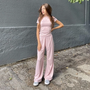 Outdoor shot of a light pink two-piece casual set with short sleeve top and wide leg pants