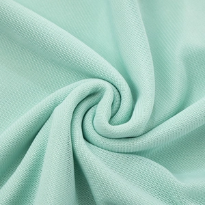 Detailed close-up of mint green mesh fabric showing soft texture and pleated elastic weave