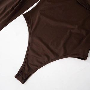 Detail view of brown sleeveless bodysuit featuring snap button closure and elastic fabric
