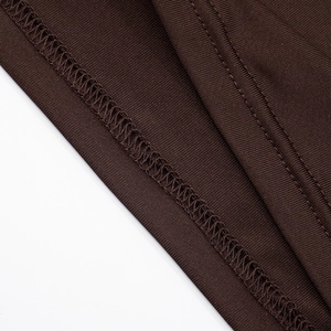 Macro detail of dark brown ribbed knit fabric showing neat double-needle stitching quality