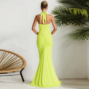Rear view of an elegant neon green backless maxi dress with stylish pleated details