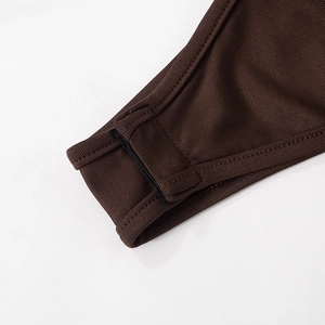 Detail view of the ribbed fabric texture and sturdy bottom closure on the bodysuit