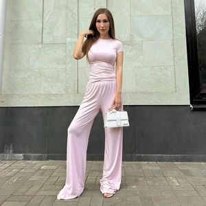 Detail of light pink two-piece set featuring slim crewneck tee and wide-leg trousers