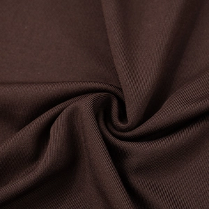 Macro shot of dark brown ribbed knit fabric showing texture and vertical stripes detail