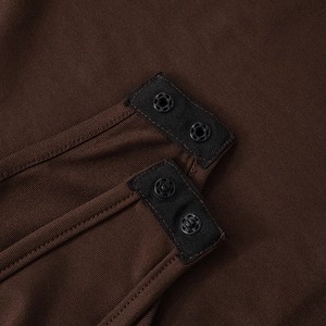 Detail shot of brown ribbed bodysuit featuring secure metal snap buttons at the bottom closure
