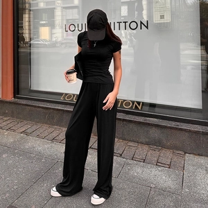 Close-up of minimalist black crewneck top and high-waist wide-leg trousers casual set