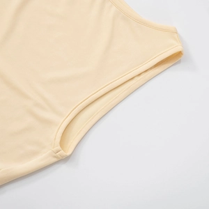 Detail of armhole stitching on a beige sleeveless dress with professional seam finish