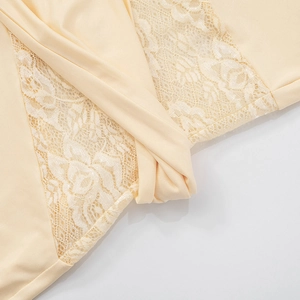 Detail shot of beige dress featuring delicate floral lace splicing and smooth fabric texture