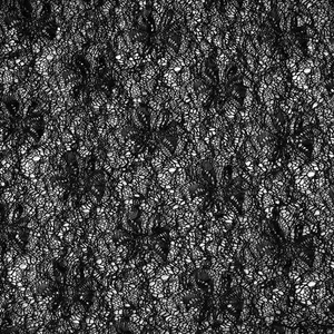 Close-up of black lace fabric with floral patterns and delicate hollow-out details