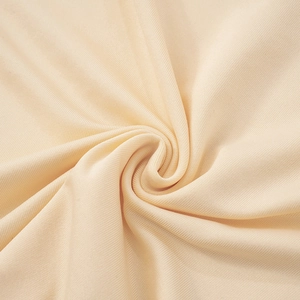 Detailed close-up of cream ribbed knit fabric texture with soft vertical grain