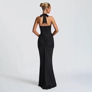 Elegant black backless halter gown with ruched waist detailing and a long fishtail skirt