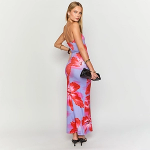 Close-up of strapless floral maxi dress with vibrant red flowers on purple fabric
