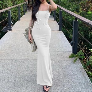 Detail of white slim fit maxi dress featuring 3D beadwork and sleek spaghetti straps