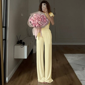Detail of light yellow knit loungewear set with crew neck top and wide leg pants