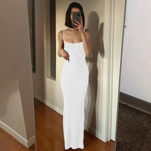 Detailed view of white bodycon dress with rhinestone embellishments and spaghetti straps