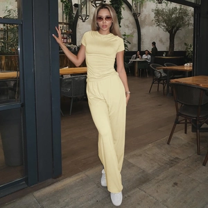 Close-up of pale yellow ribbed knit two-piece set featuring wide-leg trousers and top