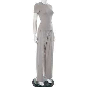 Detail of light grey two-piece set featuring a crew neck top and wide-leg trousers