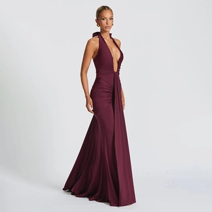 Detail view of deep burgundy halter neck dress with plunging V-neck and ruched waist