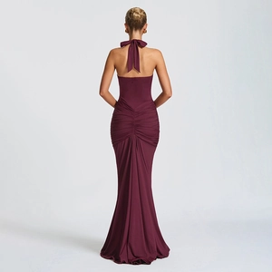 Detail of burgundy backless halter dress featuring waist ruching and elegant bow tie