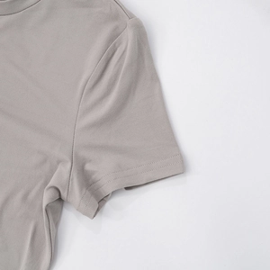 Detail shot of grey knit shirt sleeve showing high-quality double-needle stitching and fabric