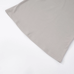 Detailed close-up showing double-needle flat stitching on gray knit trousers hem