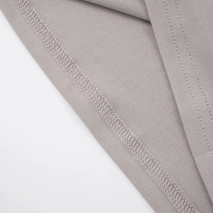 Detail view of high-quality overlock stitching and double-needle seams on grey knit fabric