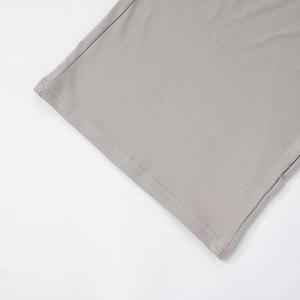 Detail shot of high-quality double-needle stitching on grey fabric trouser hem
