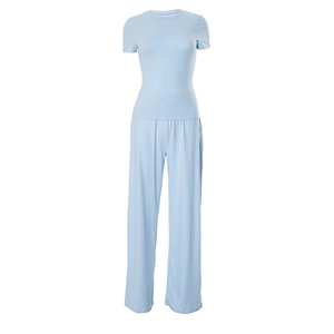 Detail of light blue two-piece lounge set with high-waisted wide-leg trousers and top