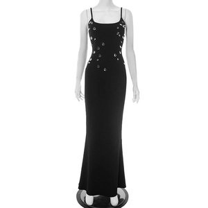 Detail of a black sleeveless bodycon maxi dress with rhinestone embellishments on the bodice