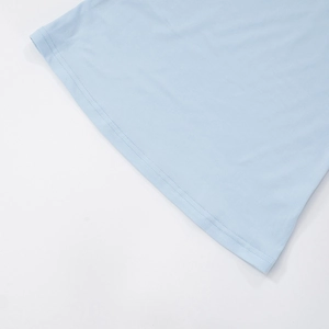 Detail shot of sky blue knitted fabric texture and double-needle hem stitching finish
