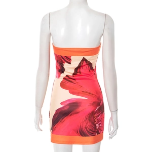 Back view of elegant floral tube dress with orange trim and split hem on white background