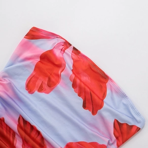 Detail shot of pink gradient floral fabric with red petals and durable twin-needle stitching