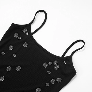 Detail of black ribbed knit dress with sparkling rhinestone water drop decorations