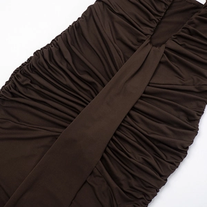 Close-up of ruched fabric texture and stitching details on a brown midi dress