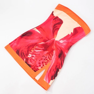Detail of red floral print mini dress with orange piping and side slit feature