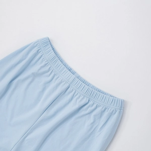 Detail of light blue wide leg pants featuring an elastic waistband with fine stitching