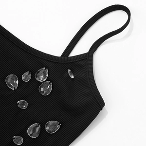 Detail of black ribbed dress with rhinestone droplets and thin spaghetti strap design