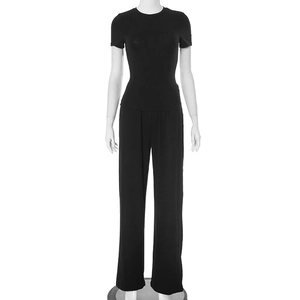 Detail of black two-piece set featuring short sleeve crew neck top and high waist wide leg pants