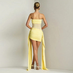 Rear view of yellow tube dress with sheer mesh insert and long hanging decorative ribbons