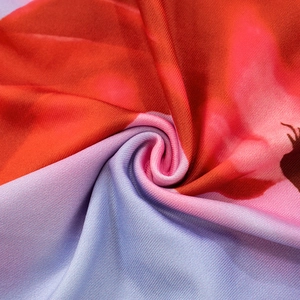 Macro shot of high-elastic floral print fabric with vibrant red and blue textured weave